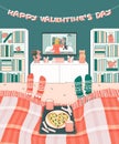 Couple is lying on the bed and watches movies on TV on Valentines Day at home. Heart Pizza, candy and coffee are on a tray.