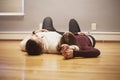 Couple lying on empty floor