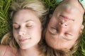 Couple lying in grass sleeping Royalty Free Stock Photo
