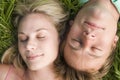 Couple lying in grass sleeping