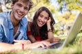 Couple lying on grass and using laptop Royalty Free Stock Photo