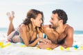 Couple lying on a towel at the beach Royalty Free Stock Photo