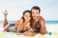 Couple lying on a towel at the beach Royalty Free Stock Photo