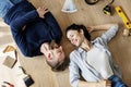 Couple lying on wooden floor Royalty Free Stock Photo