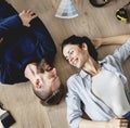 Couple lying on wooden floor Royalty Free Stock Photo