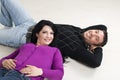 Couple lying on wooden floor Royalty Free Stock Photo