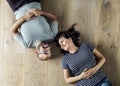Couple lying on wooden floor Royalty Free Stock Photo