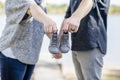Couple Makes Baby Announcement with a Tiny Pair of Shoes Outside