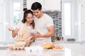 Couple making bakery in kitchen room, Young asian man and woman together Royalty Free Stock Photo