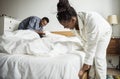 A couple making bed together Royalty Free Stock Photo