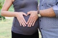 Couple making a heart shape on the pregnant belly Royalty Free Stock Photo