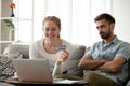 Couple making payments online with credit card using laptop