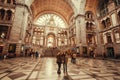 Couple making selfie on terminus of railway station Antwerpen Centraal, constructed in 1905 with passengers