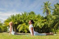 Couple making yoga cobra pose outdoors Royalty Free Stock Photo