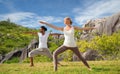 Couple making yoga in warrior pose at seaside Royalty Free Stock Photo