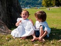 Couple of male and female children in green meadow portrait