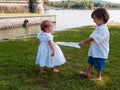 Couple of male and female children in green meadow portrait Royalty Free Stock Photo