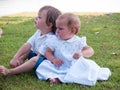 Couple of male and female children in green meadow portrait Royalty Free Stock Photo