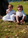 Couple of male and female children in green meadow portrait Royalty Free Stock Photo