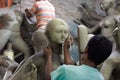 Couple of male sculptures sculpting statues of the Hindu goddess Durga