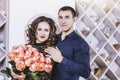 Couple man gives a woman a bouquet of flowers roses beautiful an Royalty Free Stock Photo