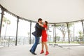 Couple, man and woman are dancing in the gazebo in the Park