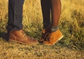 Couple man and woman feet in love romantic outdoor with autumn s