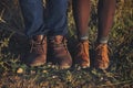 Couple man and woman feet in love romantic outdoor with autumn s