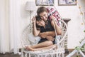 Couple man and woman in a hanging chair cuddling Royalty Free Stock Photo