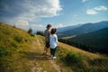 Couple man and woman look distance hiking trip, the mountain trail. Carpathians mountains, hiker couple enjoying the beautiful Royalty Free Stock Photo