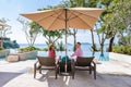 couple man and woman mid age in swimming pool on a luxury vacation in Thailand, men and Asian woman in pool looking out Royalty Free Stock Photo