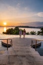 couple man and woman mid age in swimming pool on a luxury vacation in Thailand, men and Asian woman in pool looking out Royalty Free Stock Photo