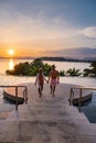 couple man and woman mid age in swimming pool on a luxury vacation in Thailand, men and Asian woman in pool looking out Royalty Free Stock Photo