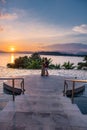 couple man and woman mid age in swimming pool on a luxury vacation in Thailand, men and Asian woman in pool looking out Royalty Free Stock Photo