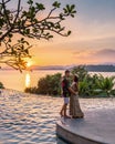 couple man and woman mid age in swimming pool on a luxury vacation in Thailand watching sunset Royalty Free Stock Photo