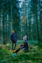 couple man and woman mid age walking in the forest during Autumn season in nature trekking with orange red color trees Royalty Free Stock Photo