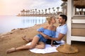 Couple man and woman on the ocean seashore - romantic hugs