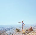 Couple Man and Woman on top of mountain enjoying beautiful landscape cityscape Athens Greece on background Tourists Royalty Free Stock Photo