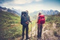 Couple Man and Woman Travelers backpackers mountaineering