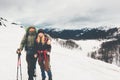 Couple Man and Woman travelers climbing foggy mountains