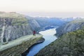 Couple Man and Woman on Trolltunga cliff raised hands mountains Love and Travel emotions Lifestyle concept. Young family traveling