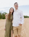 a couple of a man and a woman are walking on the beach or running along the sand along the seashore. beautiful and young Royalty Free Stock Photo