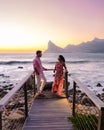 couple man and women drinking coffee on the balcony during sunrise in Cape Town South Africa. Royalty Free Stock Photo