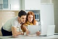 Couple managing finances, reviewing bank accounts using laptop computer Royalty Free Stock Photo