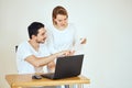 Couple managing finances, reviewing bank accounts using laptop. Woman and man doing paperwork together Royalty Free Stock Photo