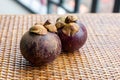 Couple mangosteen whole fruits of asia on wooden table