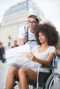 Couple with map lady in wheelchair Royalty Free Stock Photo