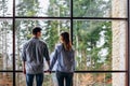 Couple or marriage in his new home looking through the window Royalty Free Stock Photo