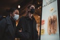 Couple in masks walking through busy Soho area, Celebrating the end of Coronavirus Lockdown Royalty Free Stock Photo