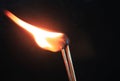 Couple of matches burning together with heat flame isolated on a black background. Royalty Free Stock Photo